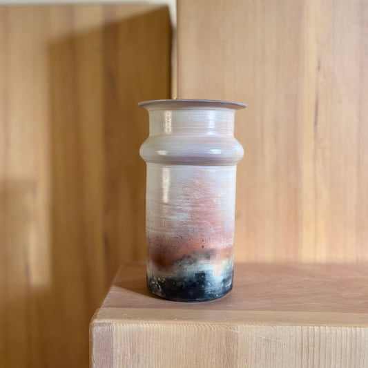 A porcelain saggar-fired vase in natural peach and black colors. Made by Hillit Wahlberg