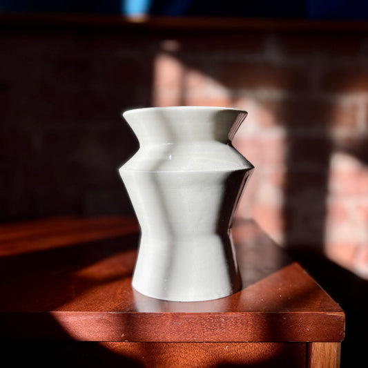 A white porcelain angular vase  finished with a clear glaze. Made by Hillit Wahlberg