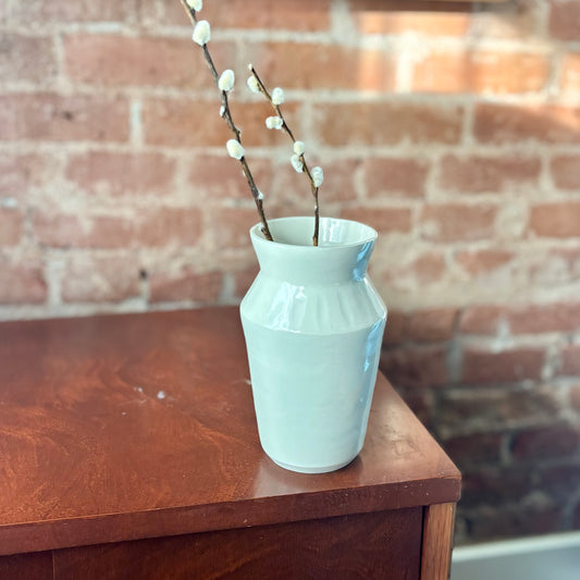 A white porcelain vase subtly carved with an etching technique. Made by Hillit Wahlberg