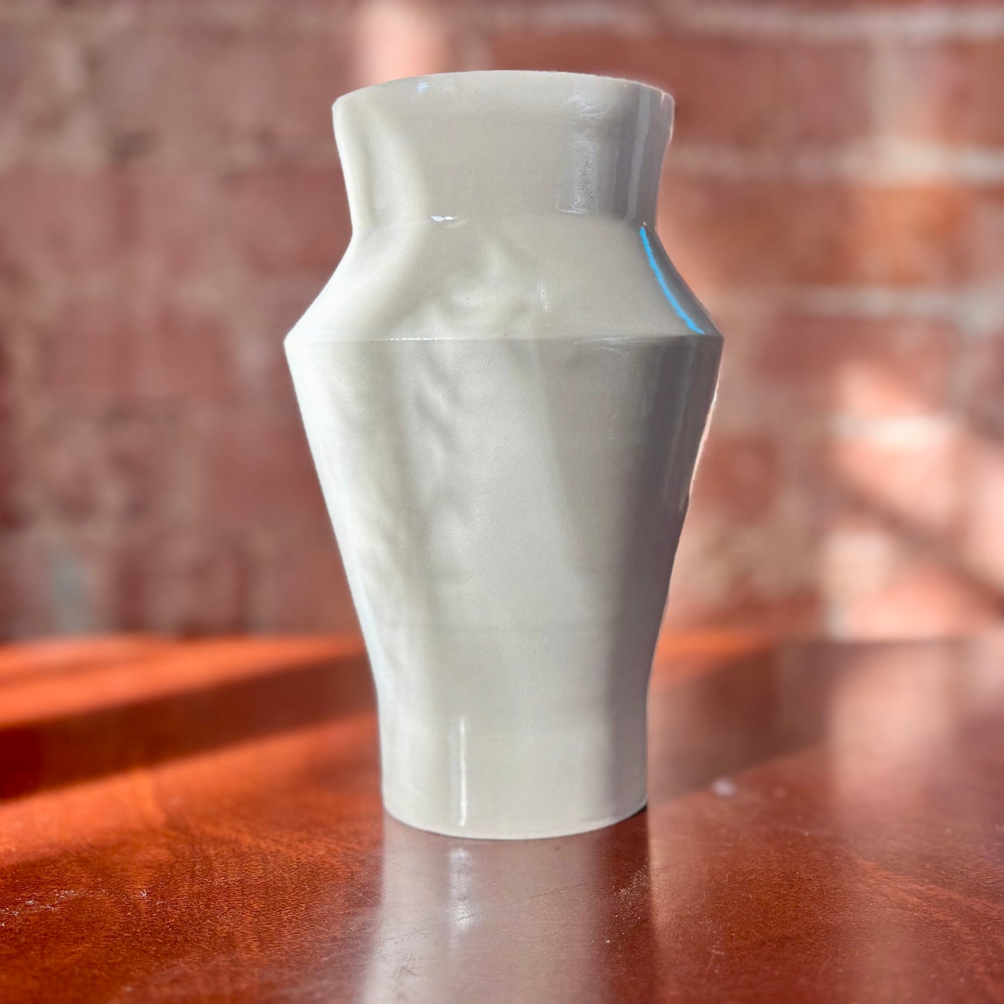 Angular white porcelain vase with a clear shiny finish. Made by Hillit Wahlberg