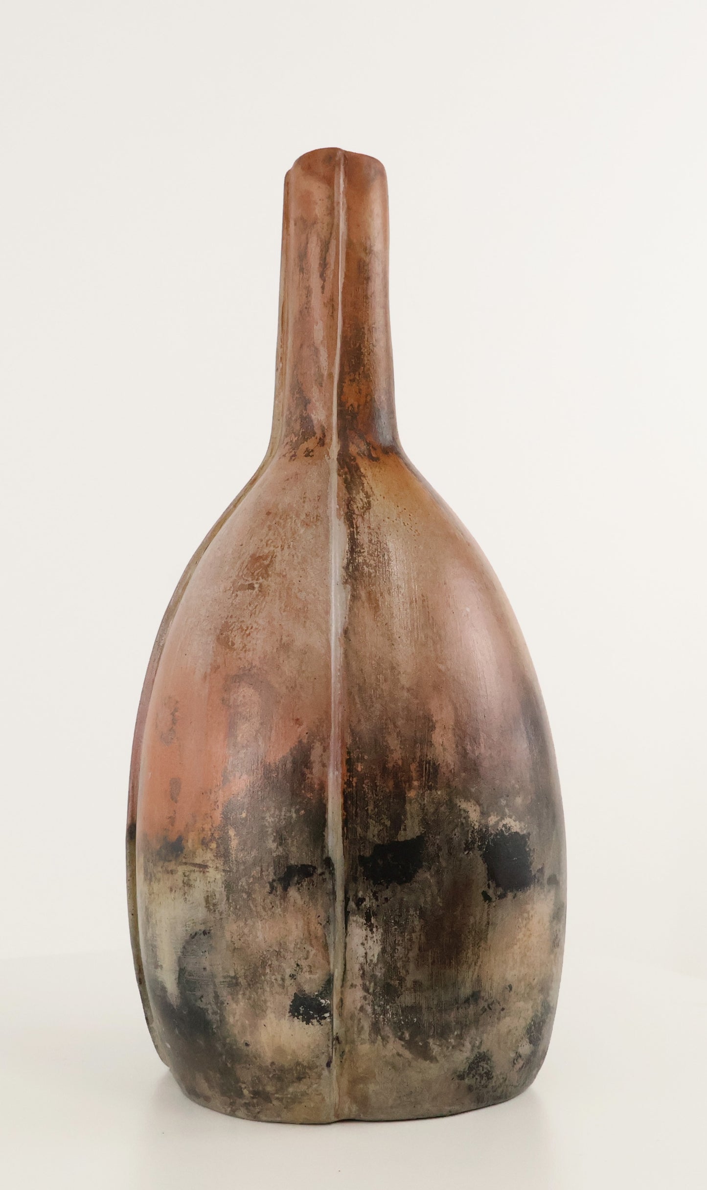 A rustic, handcrafted ceramic vase with a bulbous, rounded body and a narrow neck, featuring a mottled glaze of earthy brown, terracotta, and charcoal black on a white background.
