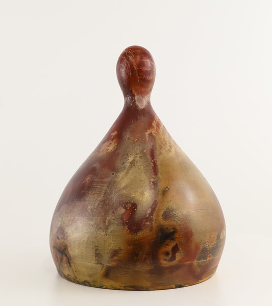 A sculptural teardrop-shaped vase made of polished agate or marble, featuring natural marbled patterns in brown, gold, and cream, set against a plain white background.