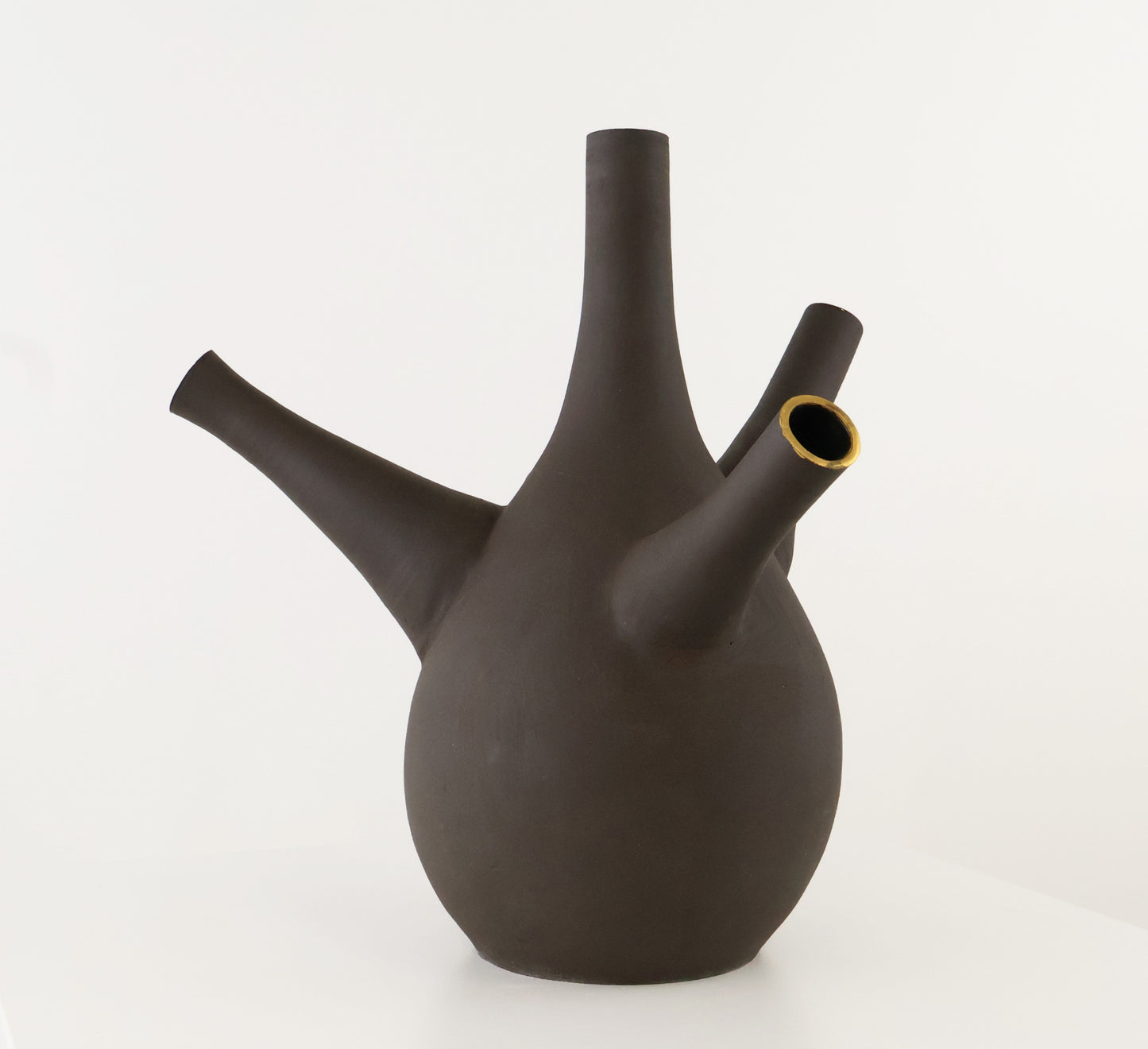 A dark brown ceramic vase with a bulbous body, a tall central spout, a side spout, and a small open mouth lined with gold-colored material, set against a plain white background.