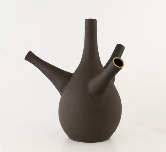 A dark brown ceramic vase with a bulbous body, a tall central spout, a side spout, and a small open mouth lined with gold-colored material, set against a plain white background.
